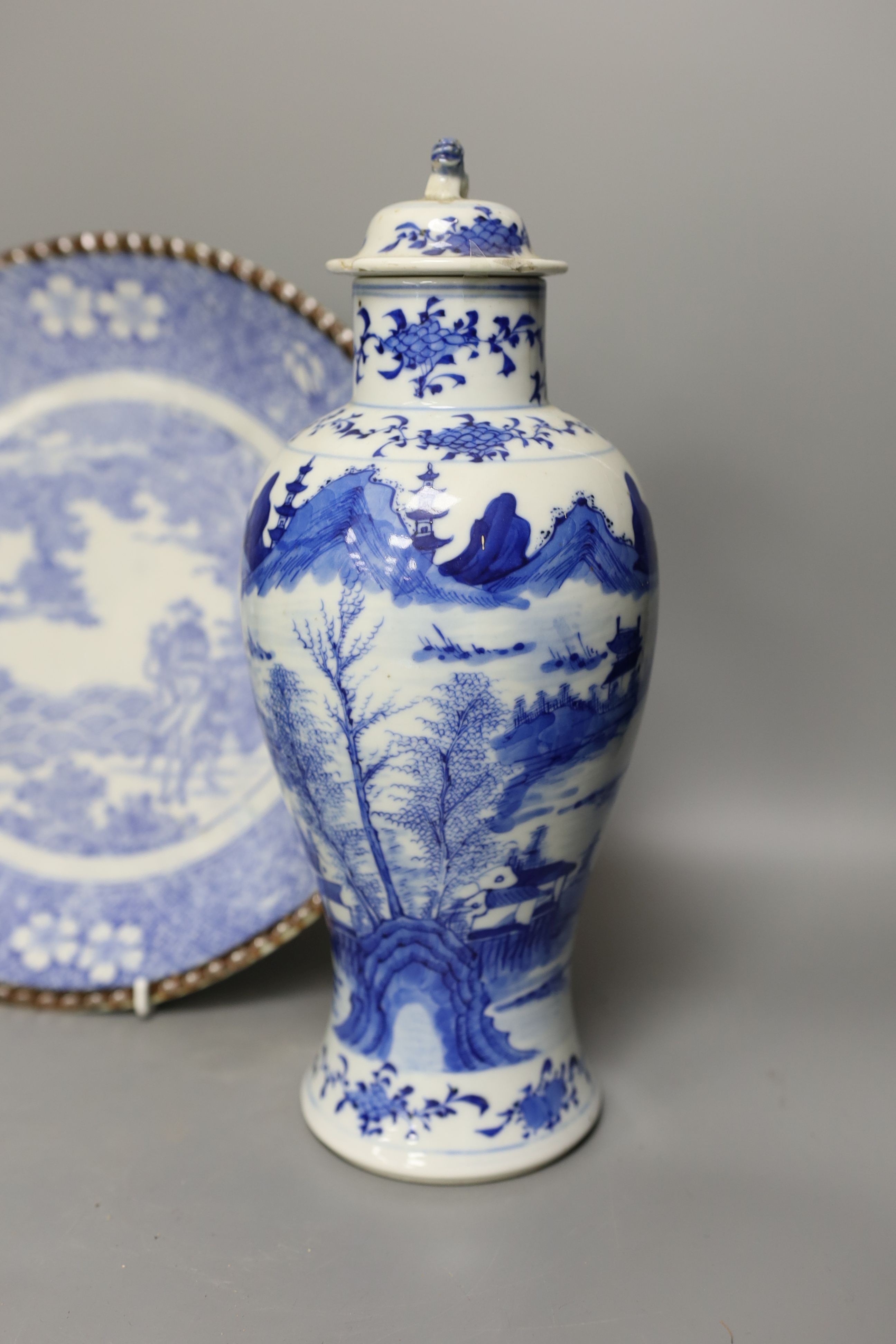 An early 20th century Chinese blue and white lidded vase together with a similar enamelled pottery vase and a Japanese blue and white dish. Tallest vase 29cm